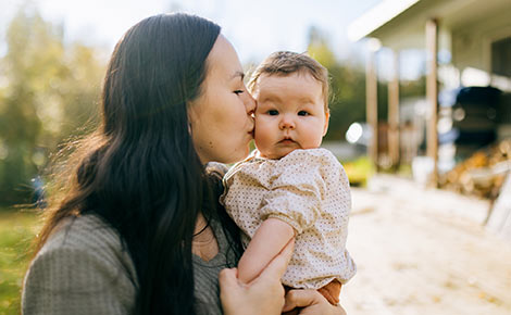 Woman kissing her baby girl