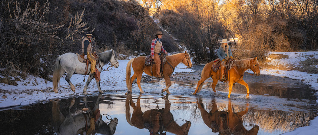 People riding horses during the winter