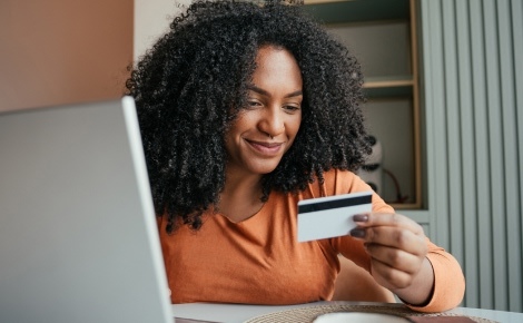 Woman making card purchase on her laptop at home