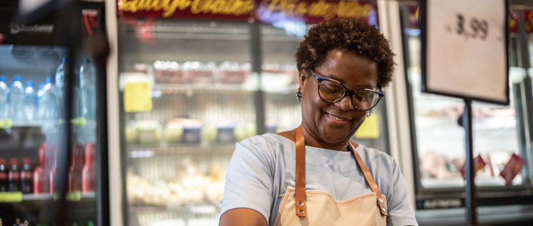 Business owner smiling while working in her store